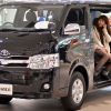 The Toyota Hiace minivan seen at the Tokyo showroom as a woman talks on the phone inside its cabin