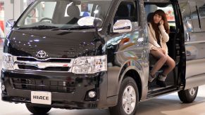 The Toyota Hiace minivan seen at the Tokyo showroom as a woman talks on the phone inside its cabin