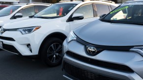 Toyota RAV4 SUVs on a car lot.