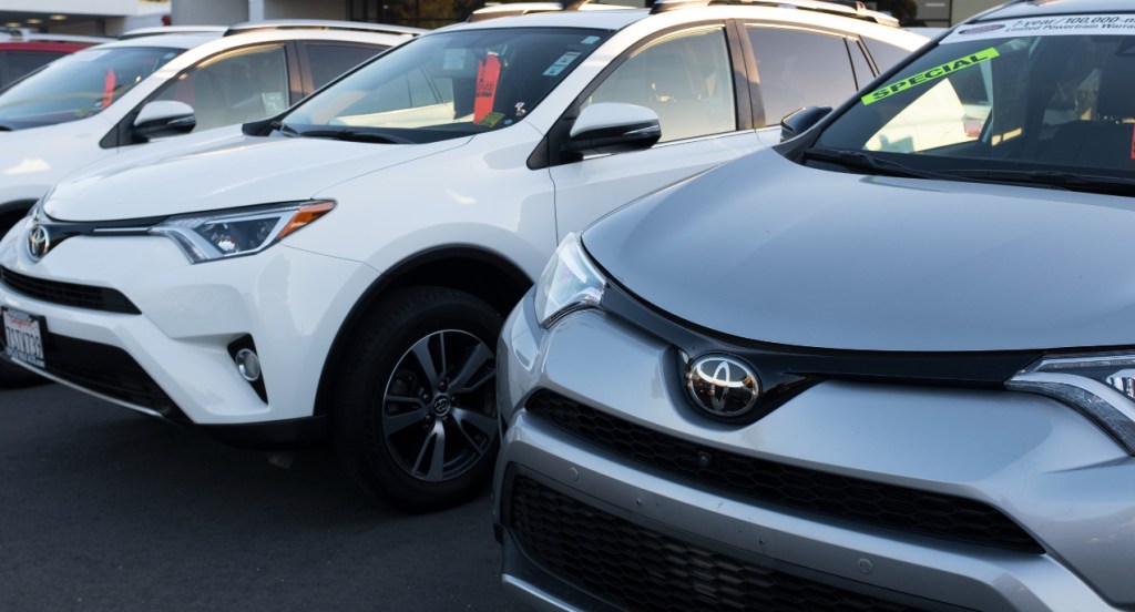 Toyota RAV4 small SUVs are parked on a lot. 