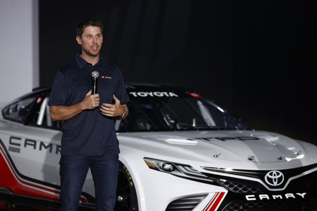 NASCAR drive on stage introducing his new V8-powered Toyota Camry race car.