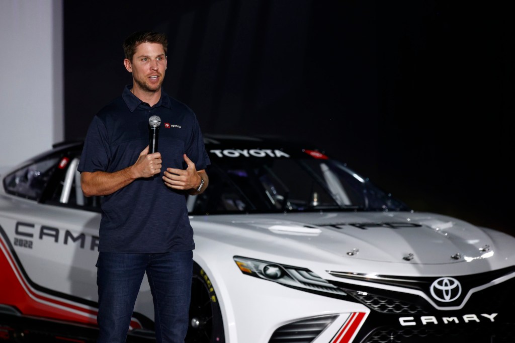 NASCAR drive on stage introducing his new V8-powered Toyota Camry race car.