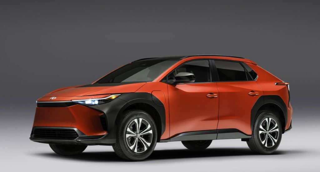 A red 2023 Toyota bZ4X XLE electric SUV. why is it cheaper than the rebadged Subaru Solterra?