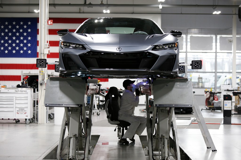 2022 Acura NSX Type S on lift for safety inspection - an inspection sticker is one of the vital things you can't forget before leaving a dealer with a used car