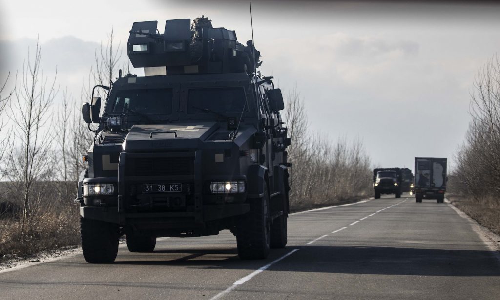 KrAZ armored troop transport driving down a road in Ukraine.