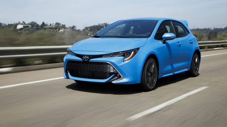 Blue 2022 Toyota Corolla Hatchback in motion, driving down a highway