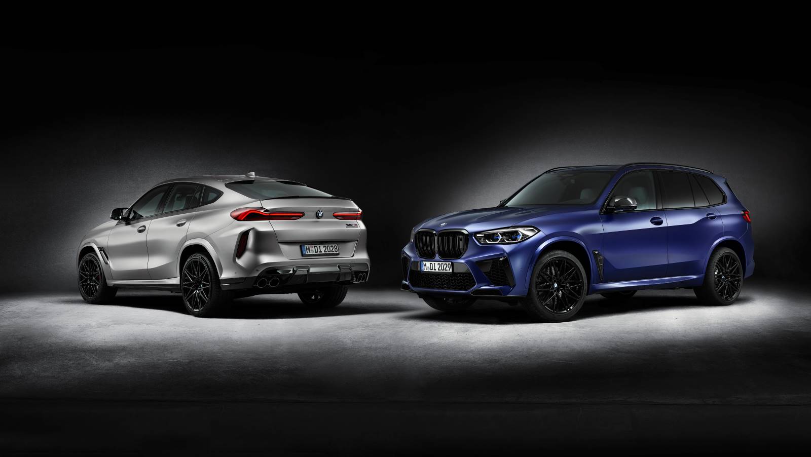 Side by side, the BMW M Series X6 M Sports Activity Coupe in silver and the M Series BMW X5 M Sports Activity Vehicle in blue