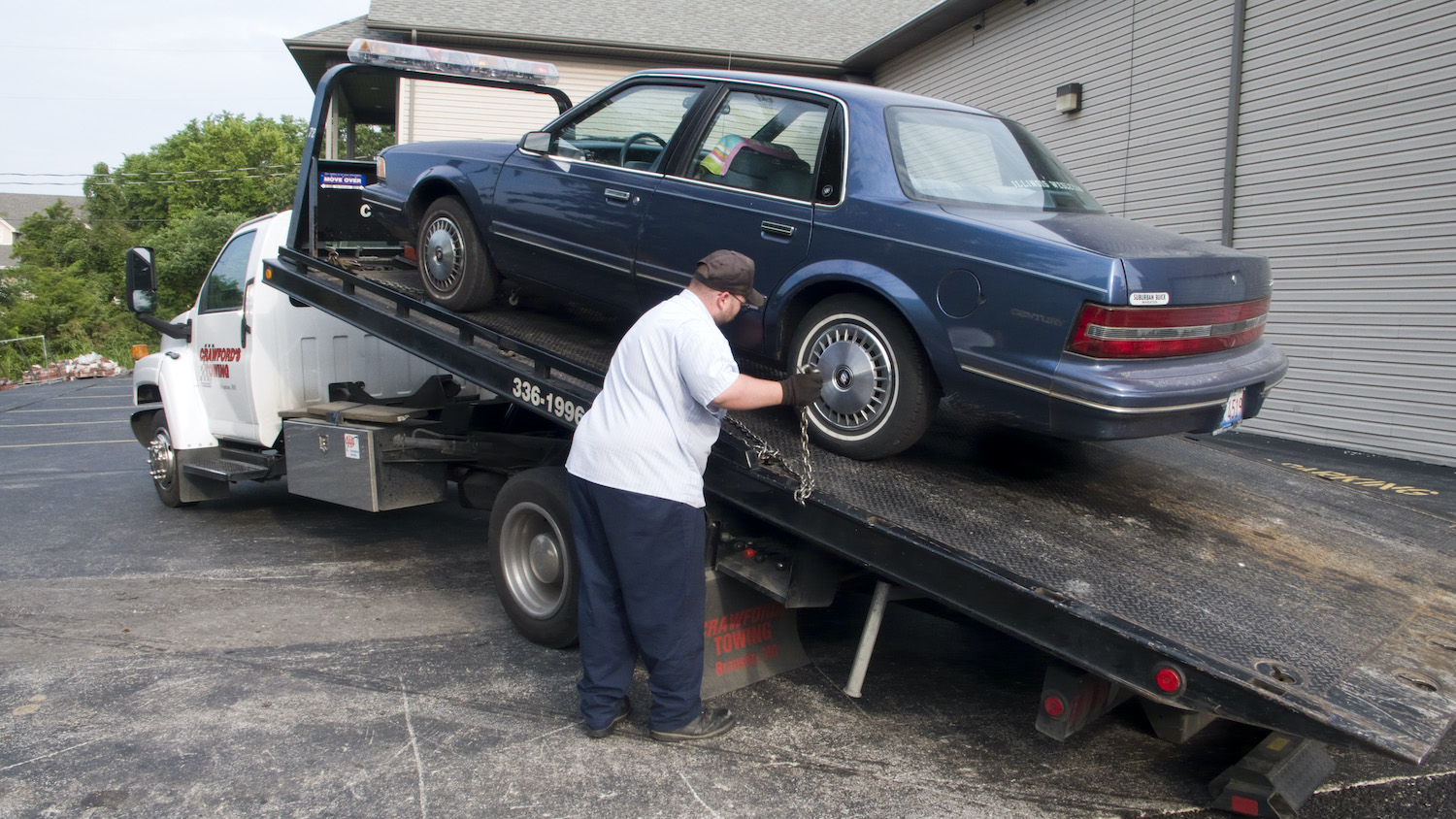 A buick getting loaded onto a tow truck