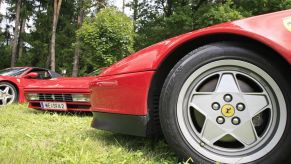 Close-up shot of a Ferrari 328 GTS sports car with the iconic five-point star hubcap