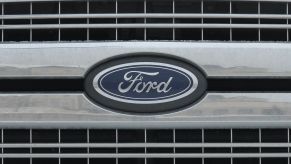 Closeup of a Ford logo nameplate on the front grille of an unidentified vehicle