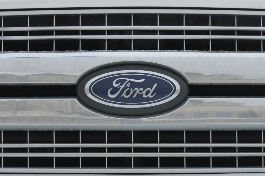 Closeup of a Ford logo nameplate on the front grille of an unidentified vehicle