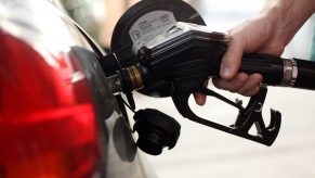 A gas pump fueling a car