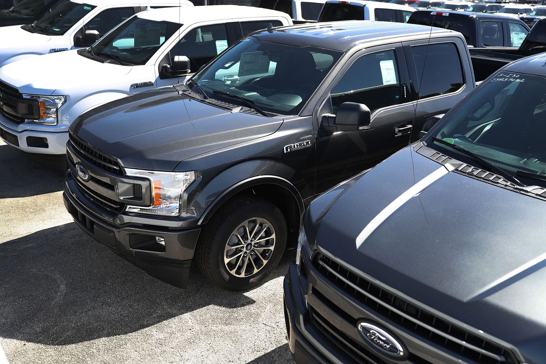 A lineup of Ford pickup truck models seen on the Metro Ford's car sales lot in Miami, Florida