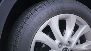 Closeup of a Goodyear tire on a Mazda car