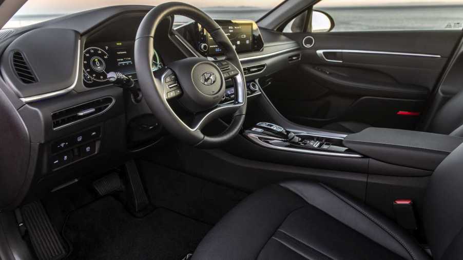Interior shot of a 2022 Hyundai Sonata Hybrid, a great rideshare car, with a black interior