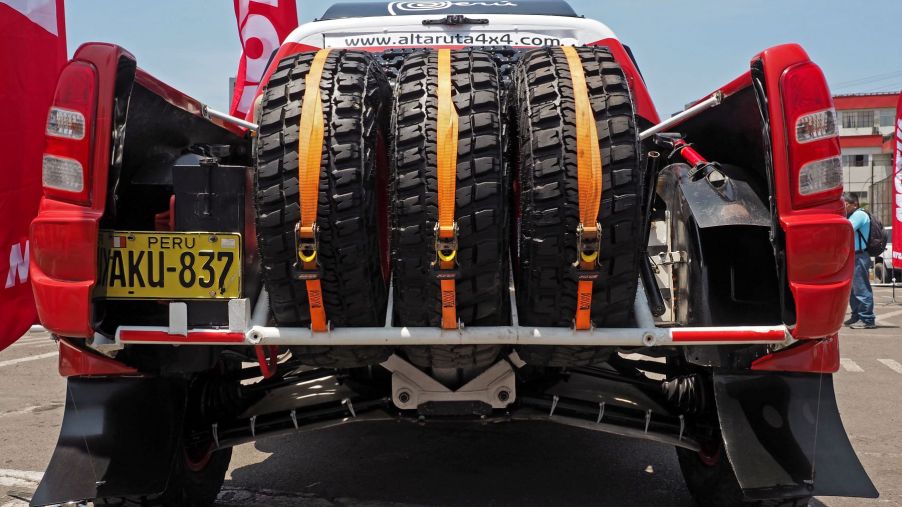 A rack of spare tires in the back of a pickup truck for the Rally Dakar in Lima, Peru