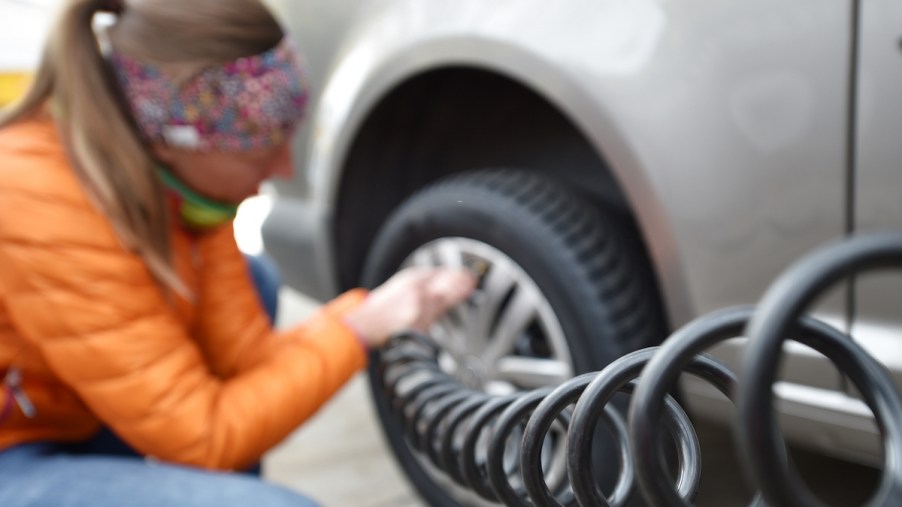 Woman tests air pressure in winter tires