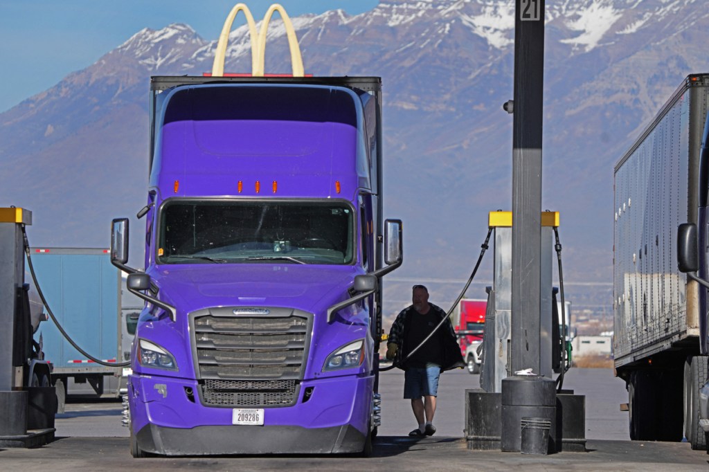 Long-haul truck driver fueling up, Should you turn off your car while pumping gas?