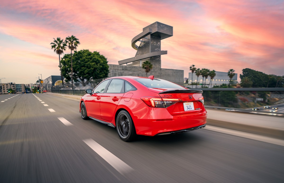 Rear angle shot of a red 2022 Honda Civic sedan, one of the best-selling new cars