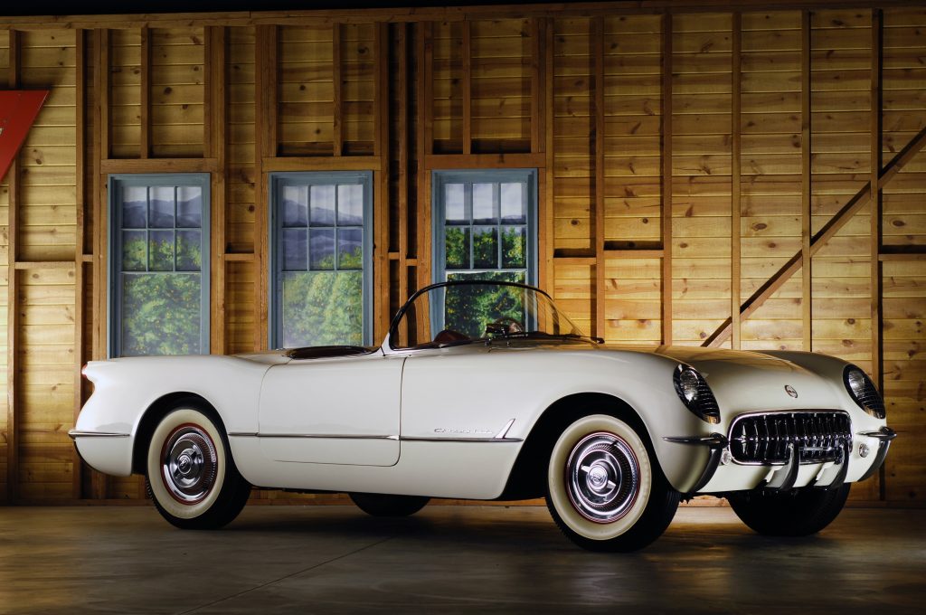A white 1954 Chevrolet Corvette in a wooden shed
