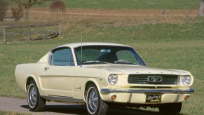 Wimbledon White 1966 Ford Mustang coupe front end driving down country road