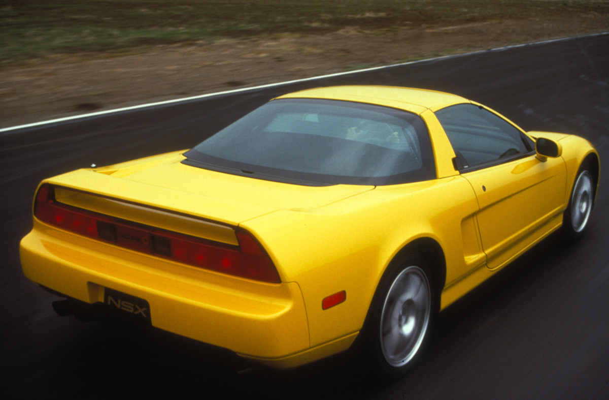 Yellow 1997 Honda NSX Coupe driving away from camera