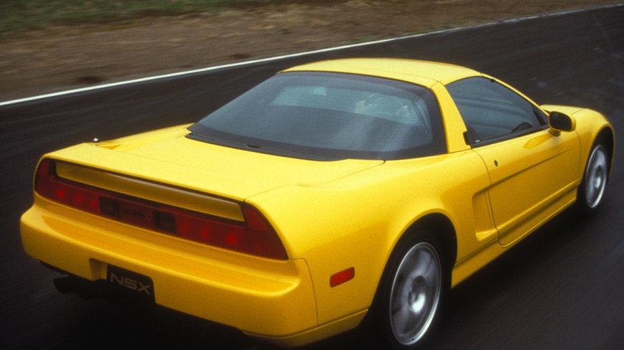Yellow 1997 Honda NSX Coupe driving away from camera