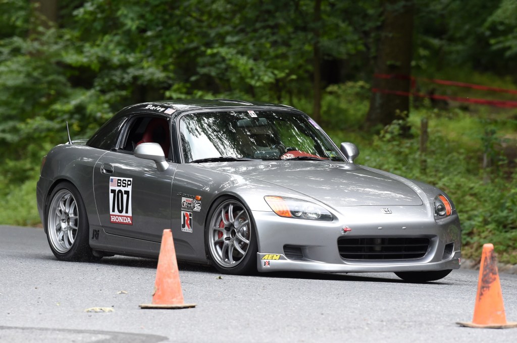 Grey 2003 Honda S2000 corners at a road course