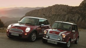 A red 2004 Mini Cooper S next to a red-with-white-stripes 1964 Mini Cooper S in the Monte Carlo hills