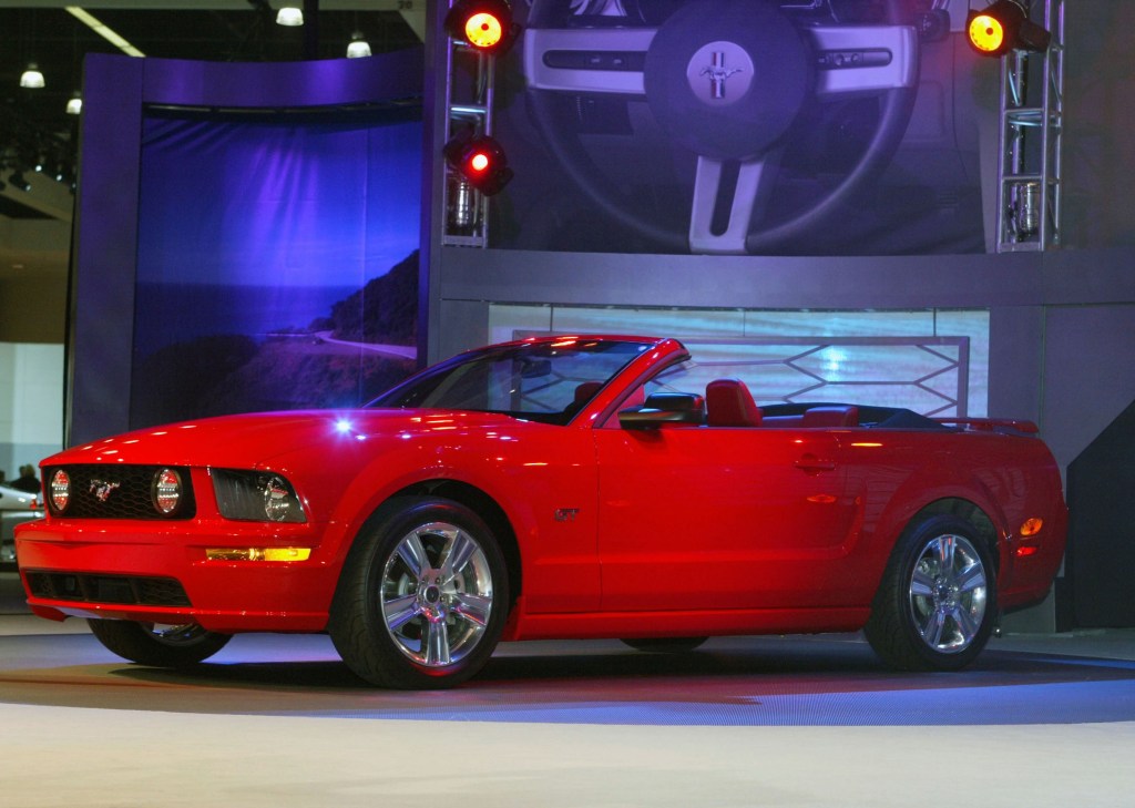 A red 2005 S197 Ford Mustang GT Convertible on the Los Angeles Auto Show stage