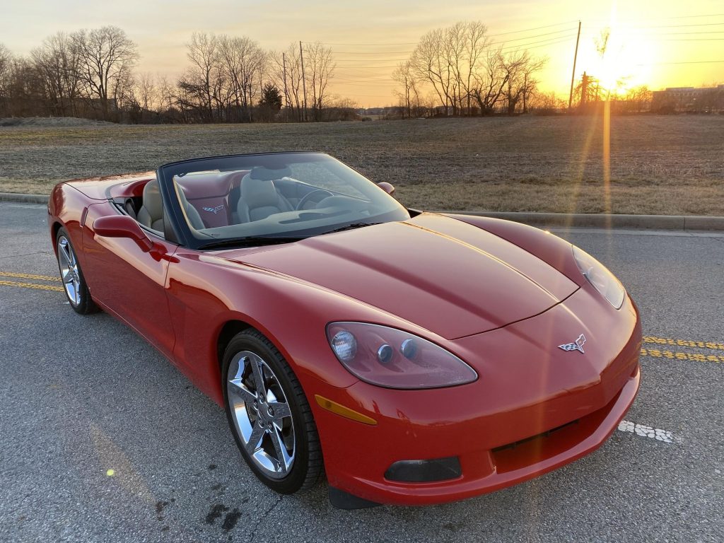 Red 2008 Chevrolet Corvette 3LT Convertible in parking lot with top down