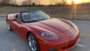 A red 2008 Chevrolet Corvette 3LT Convertible in a parking lot with its top down