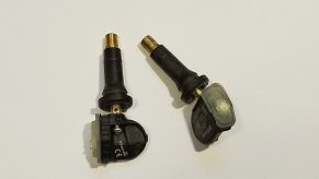 Two valve stem type 2013 Fiat 500 Abarth tire pressure sensors against a white background