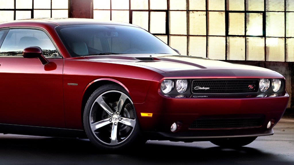 a red 2014 Dodge Challenger is parked to show its classic and muscular design
