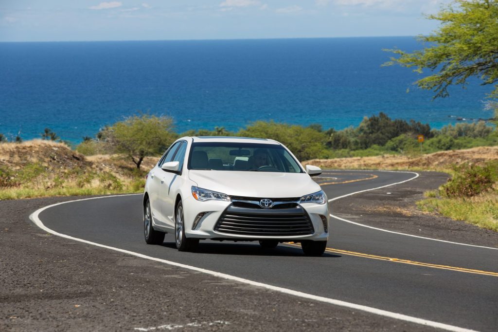 2017 Toyota Camry in white driving down a road