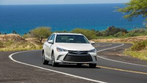 2017 Toyota Camry in white driving down a road