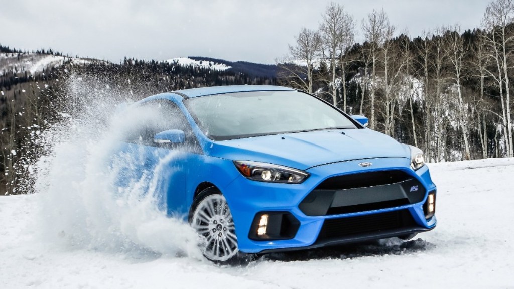 A 2016 Ford Focus RS showing off its capable all-wheel drive system by driving in the snow.