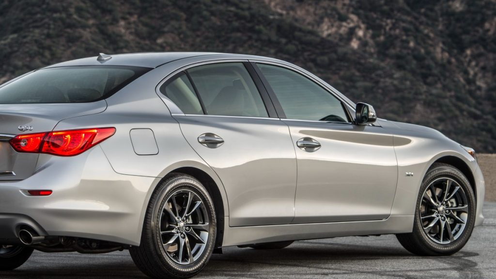 A gray 2017 Infiniti Q50 is parked showing off its sleek, aggressive and modern body lines