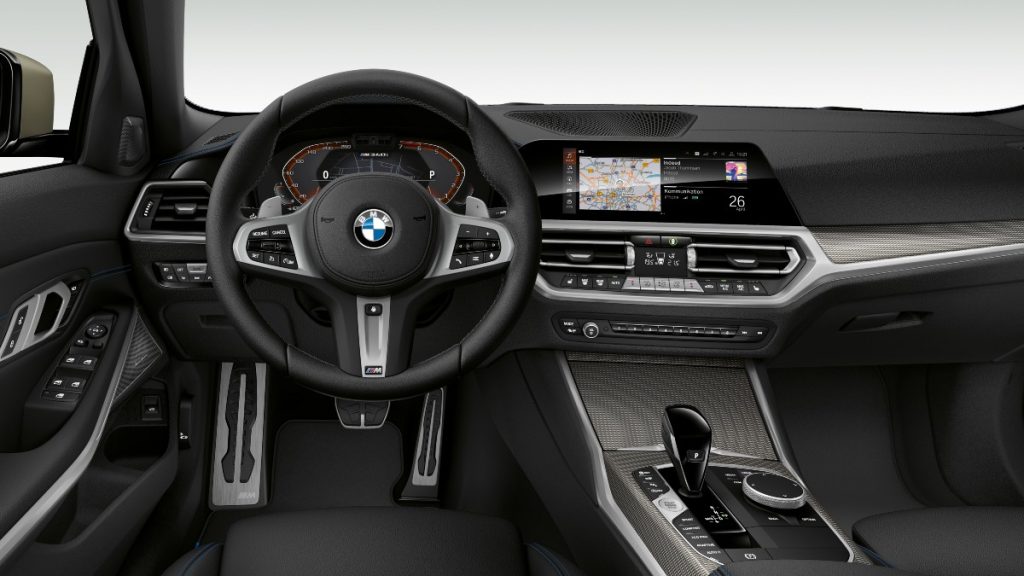 The interior of a 2022 BMW M340i sowing on the large infotainment display and top-notch luxury