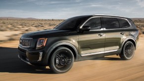 A taupe 2020 Kia Telluride parked in the desert.