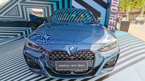 The front view of a blue 2021 BMW 4 Series at a Shanghai, China shopping mall display