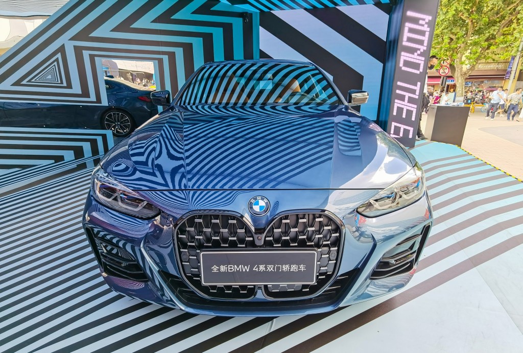 The front view of a blue 2021 BMW 4 Series at a Shanghai, China shopping mall display