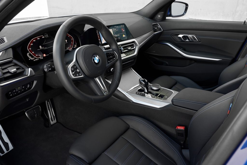 The black front seats and dashboard of a 2022 BMW 330i M Sport