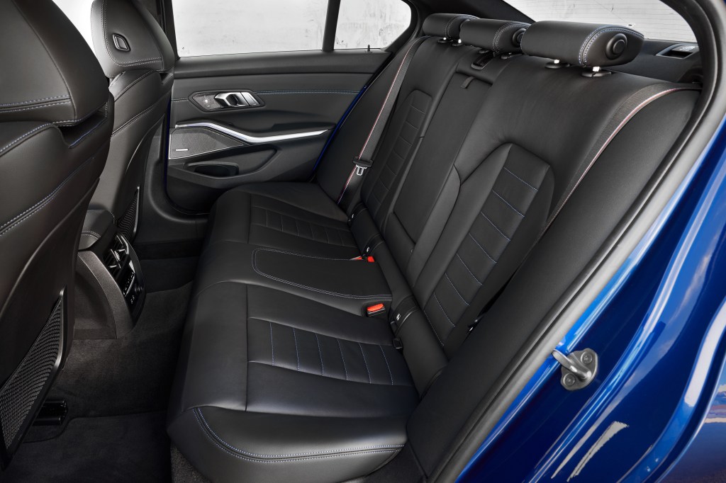 The back black seats in a blue 2022 BMW 330i M Sport