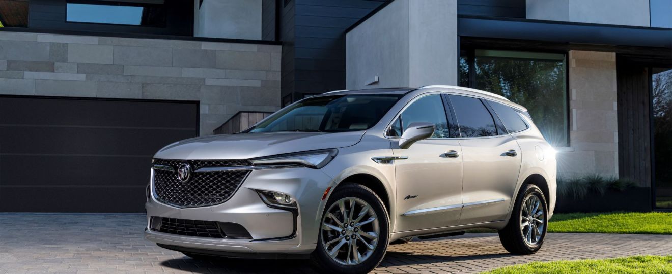 The 2022 Buick Enclave Avenir premium midsize SUV parked on a cobblestone driveway