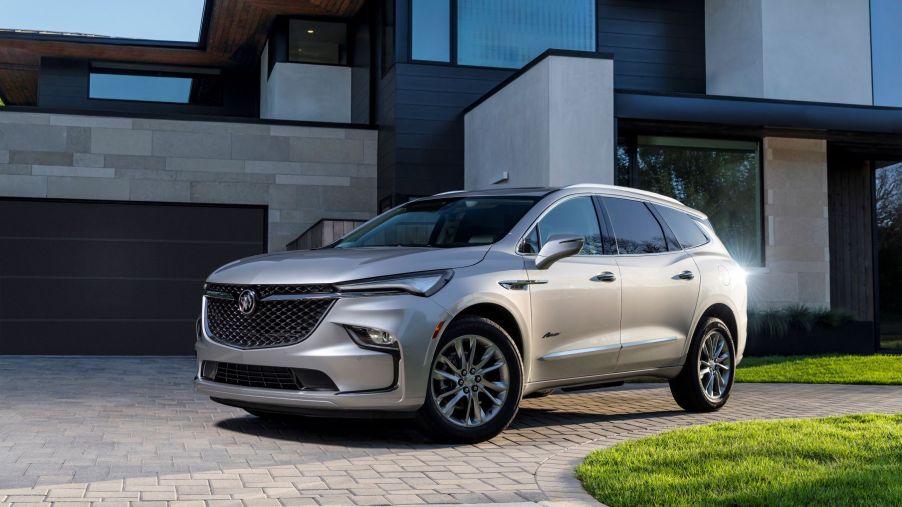 The 2022 Buick Enclave Avenir premium midsize SUV parked on a cobblestone driveway