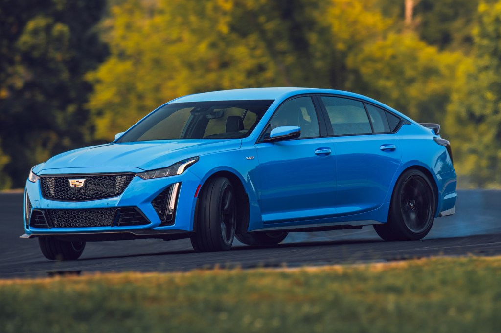 A blue 2022 Cadillac CT5-V Blackwing sliding around a racetrack