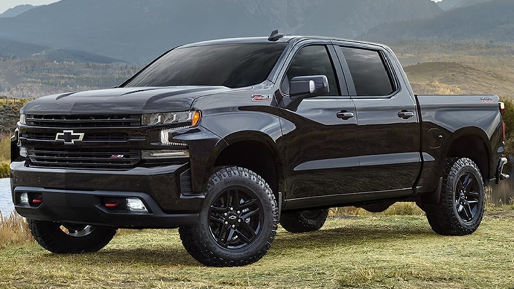 Black 2022 Chevy Silverado parked in a field.  This is a truck that can get things done.