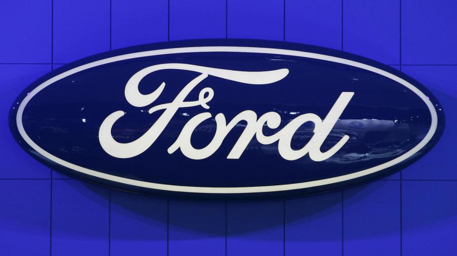 Blue Ford sign hanging on a bright blue wall.