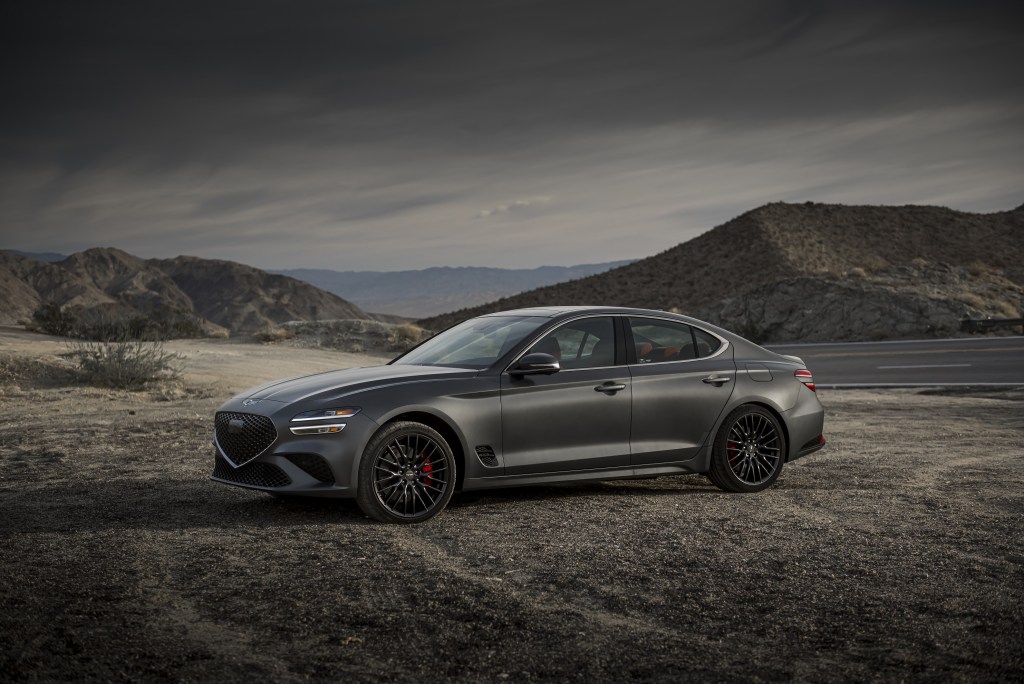 A matte-gray 2022 Genesis G70 on a mountain road